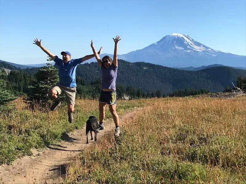 Fran and Jeff jumping outdoors